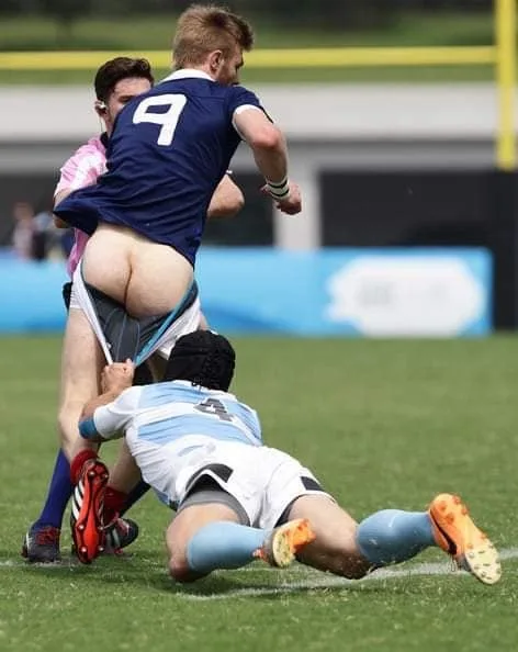 Sexy rugby lad’s ass cheek peek during intense tackle on field