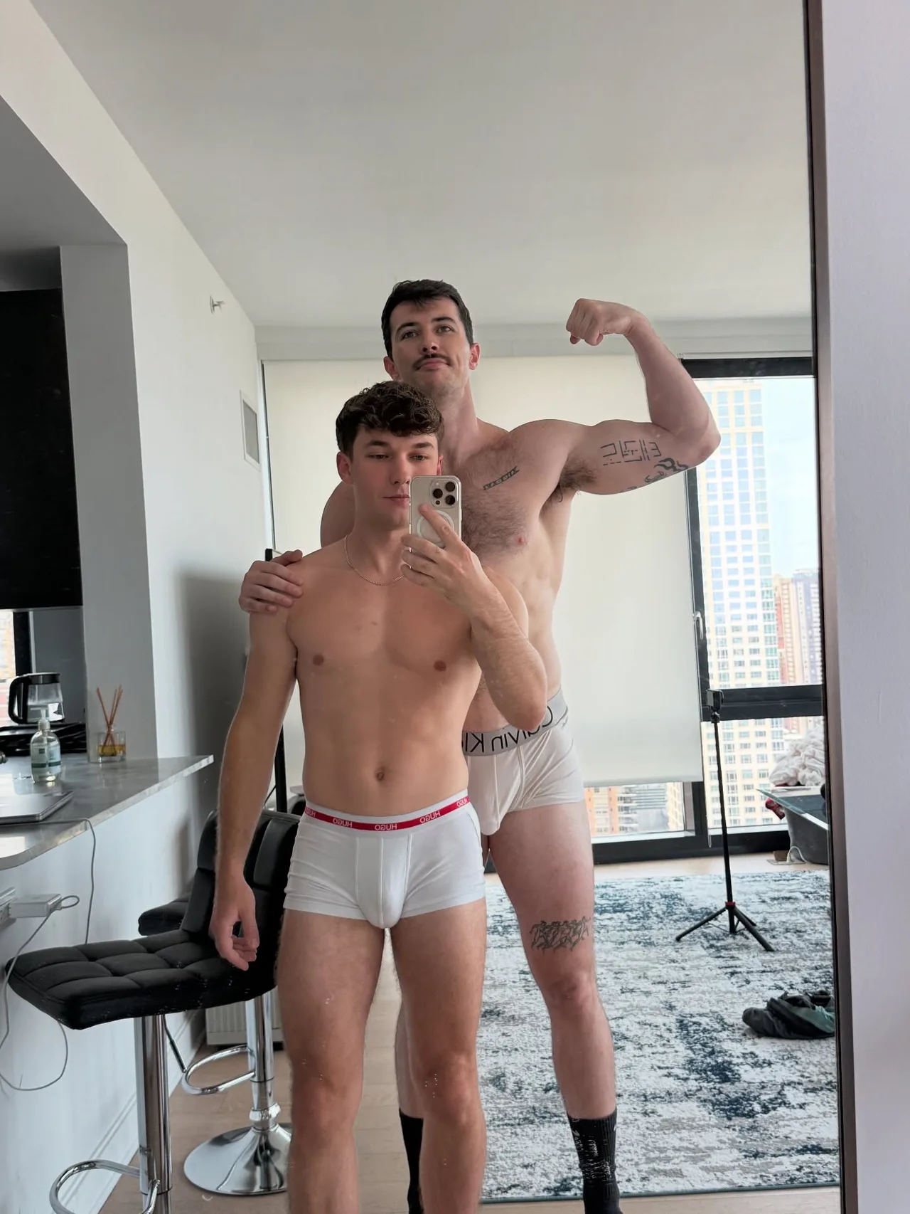 Two hot guys flexing shirtless in their underwear for a mirror selfie at home - photo 7