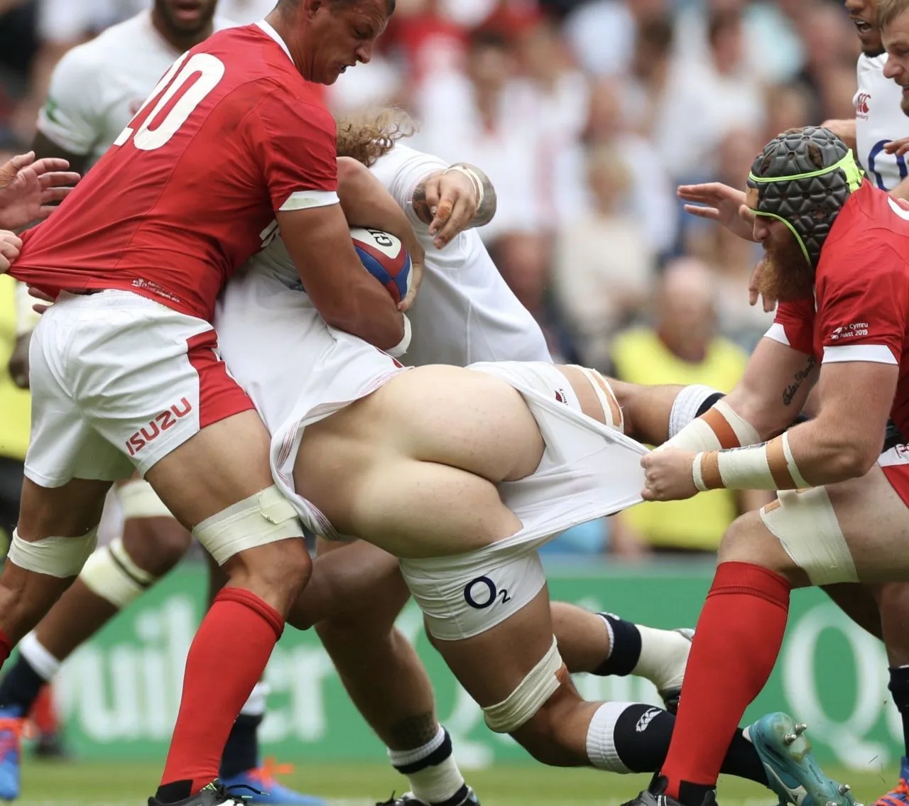 Sexy rugby lad’s white shorts ripped wide open mid-tackle, ass cheeks fully exposed in action