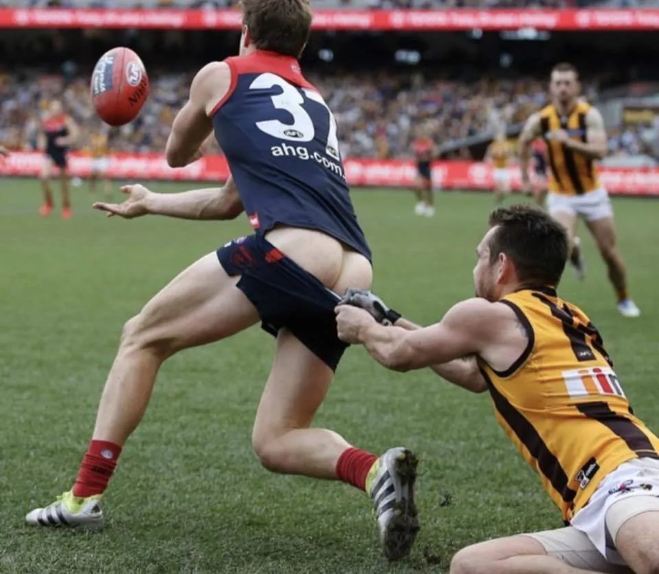 Hard athletic lad in action with shorts ripped wide open mid-game