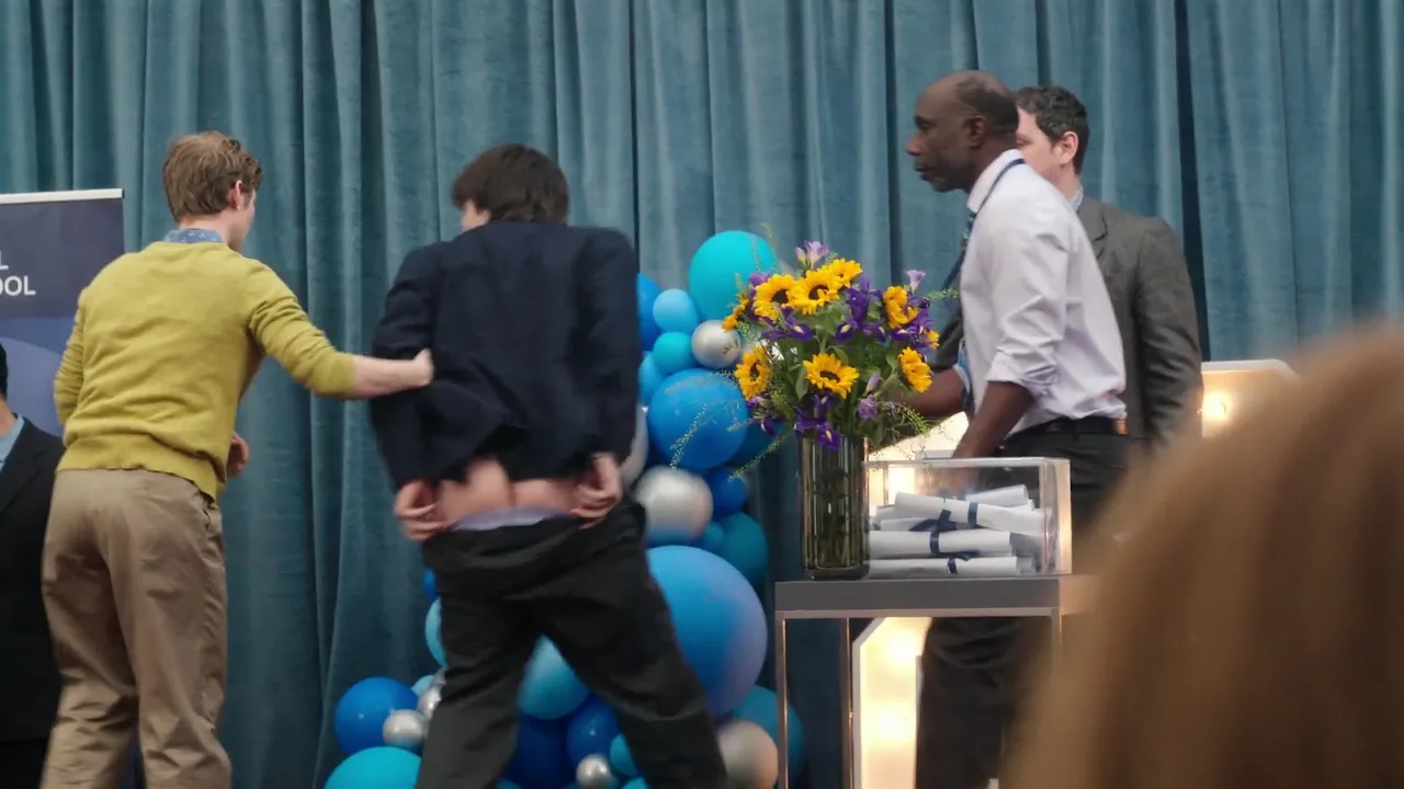 Aran Murphy’s cheeky bare ass flash during chaotic stage moment, suit pulled up for full mooning view - photo 3