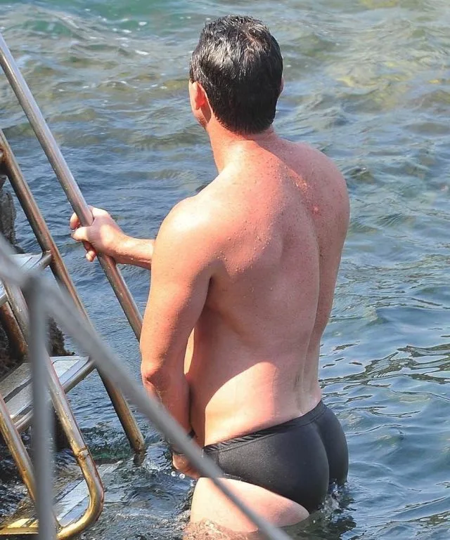 Luke Evans Shirtless in Black Swim Briefs Climbing from Sea - photo 2