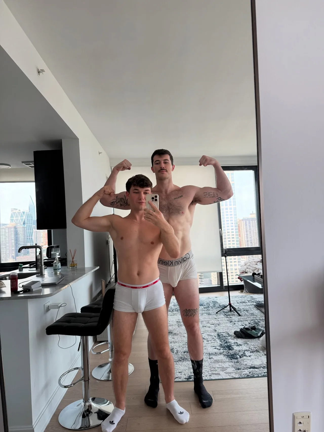 Two hot guys flexing shirtless in their underwear for a mirror selfie at home - photo 5