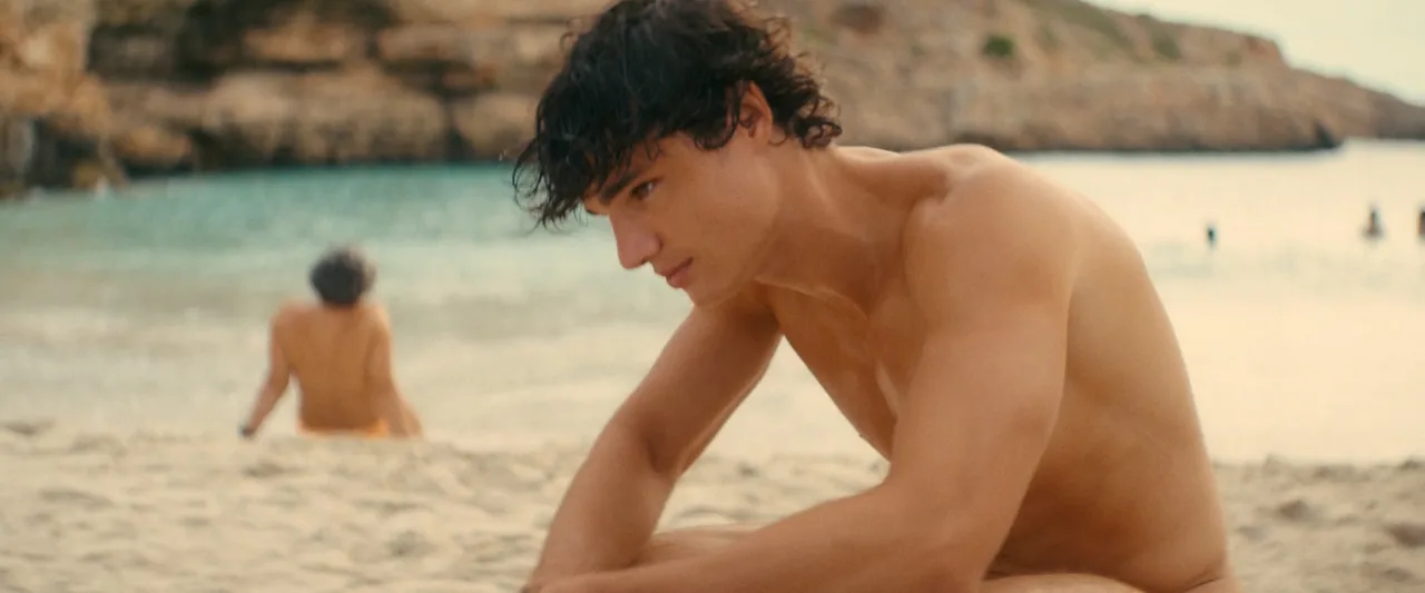 Fernando Lindez bare-chested and nude from behind on rugged beach, muscular physique on display near rocky shore - photo 3