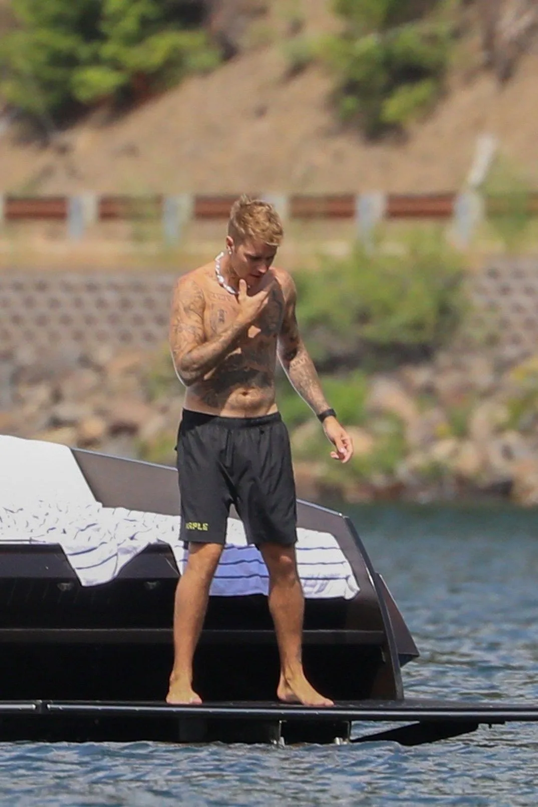 Justin Bieber Shirtless on a Yacht Deck Barefoot and Tattooed