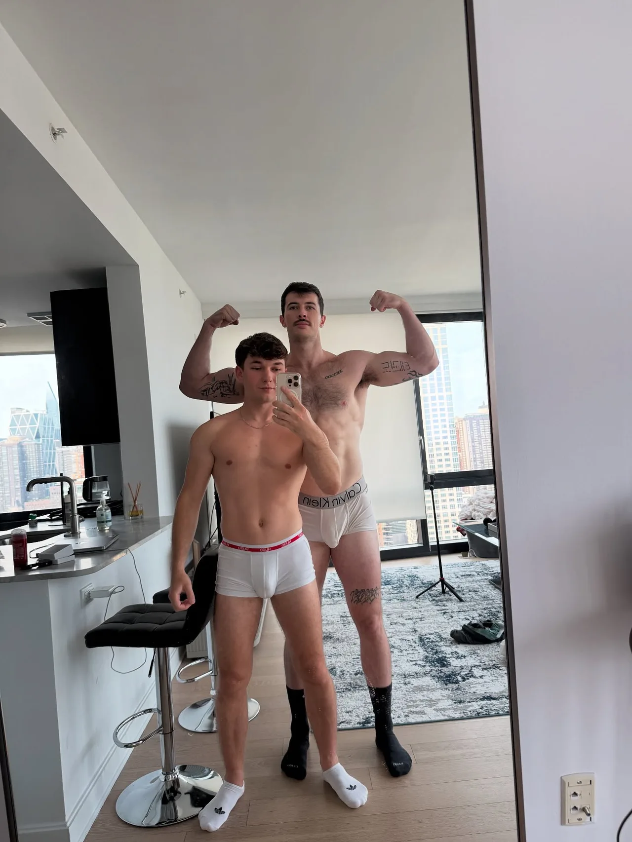 Two hot guys flexing shirtless in their underwear for a mirror selfie at home - photo 6