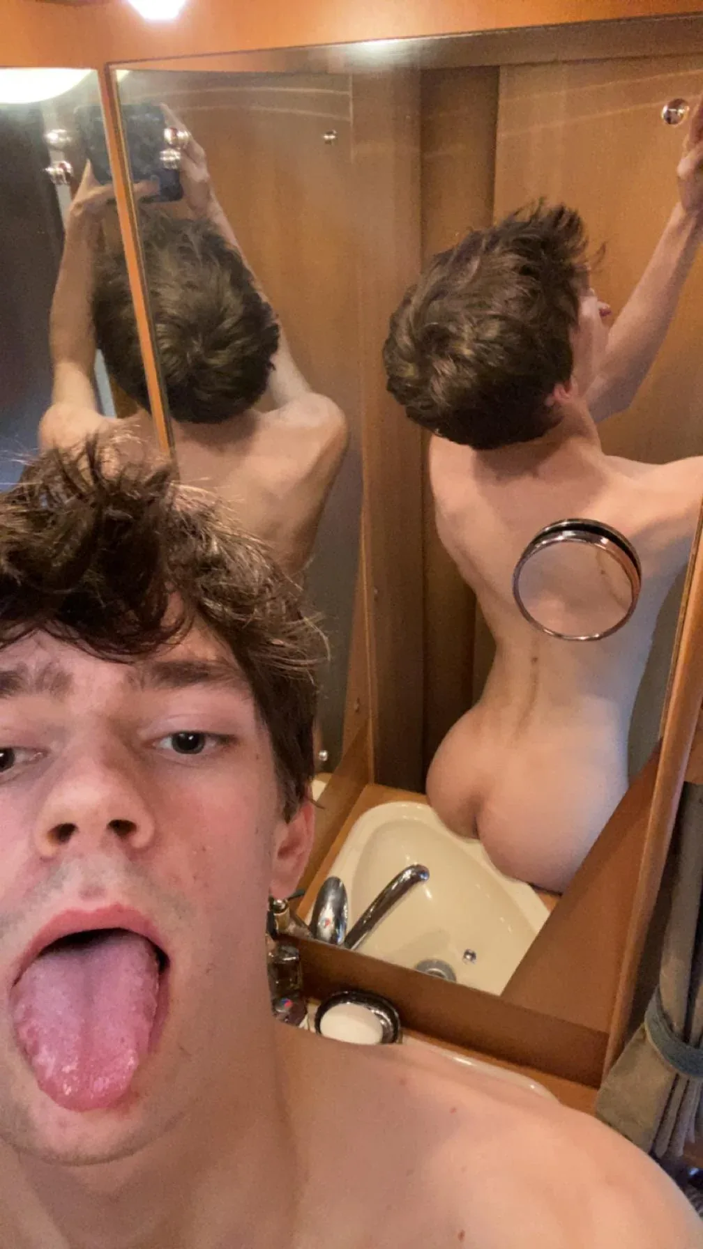 Skinny twink takes mirror selfies showing off his hard cock and tight ass in the bathroom - photo 1