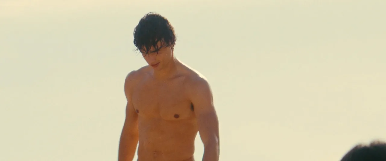 Fernando Lindez bare-chested and nude from behind on rugged beach, muscular physique on display near rocky shore - photo 1