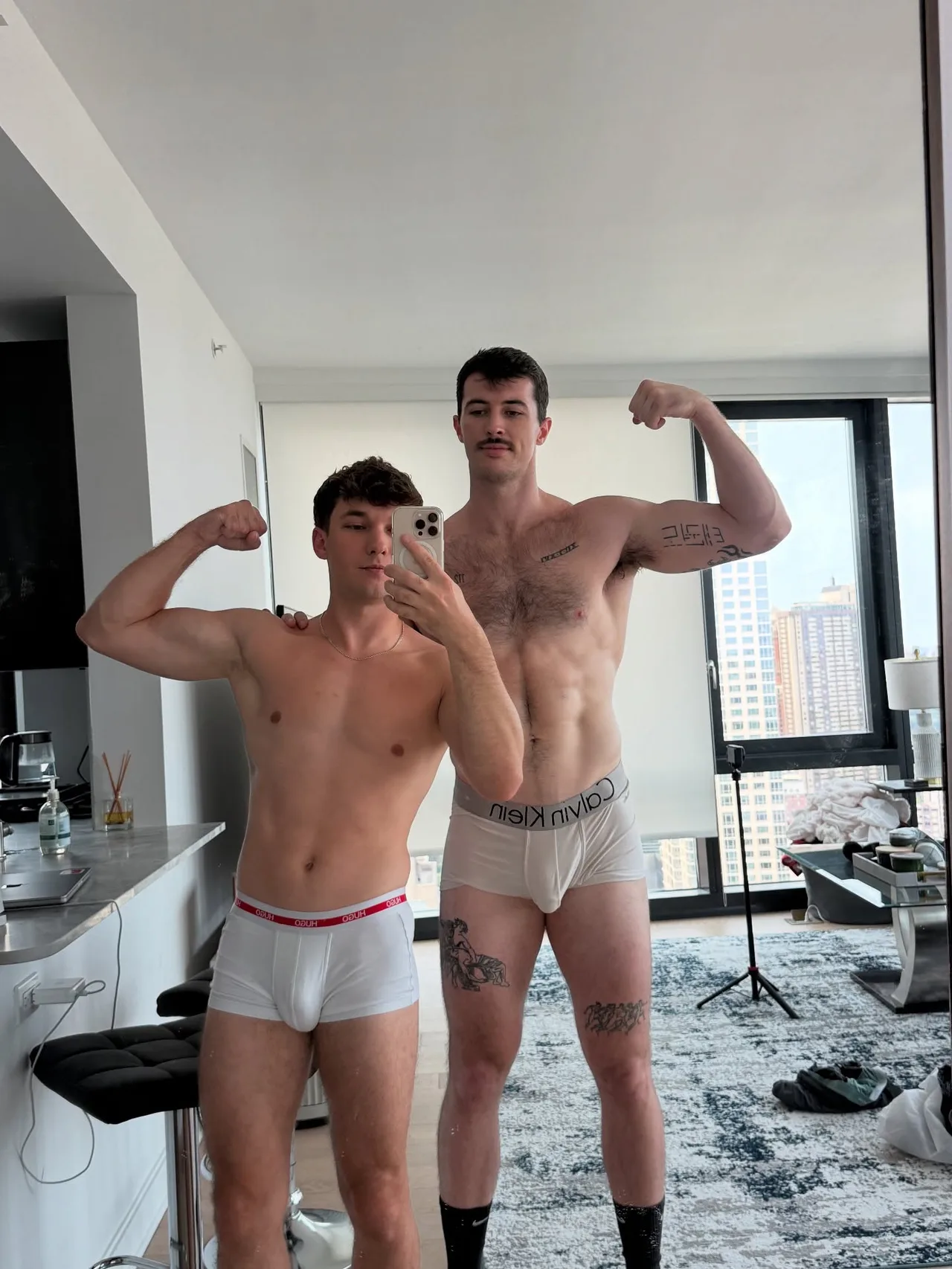 Two hot guys flexing shirtless in their underwear for a mirror selfie at home - photo 8