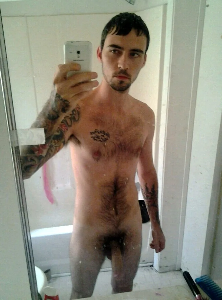 Bearded tattooed guy takes a steamy bathroom mirror selfie showing his hairy body and hard cock