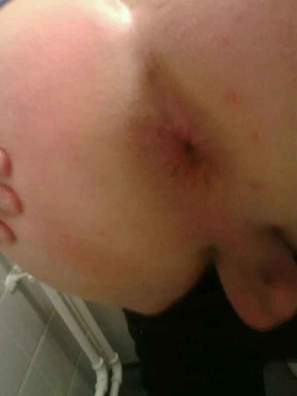 Amateur guy’s bare ass cheek and pubes in a steamy bathroom selfie