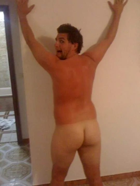 Naughty lad caught mid-stretch with bare ass on full display against the wall