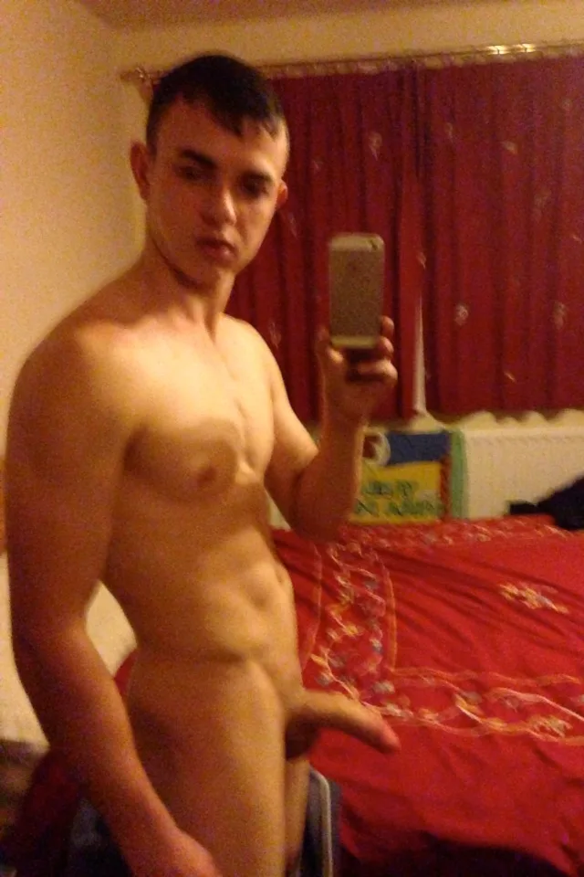 Amateur lad takes a hot mirror selfie showing off his hard cock and toned abs in bedroom
