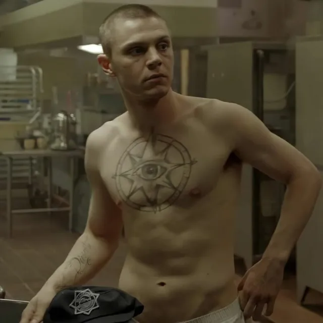 Shirtless Evan Peters flaunts chiseled abs and chest tattoo in moody kitchen scene