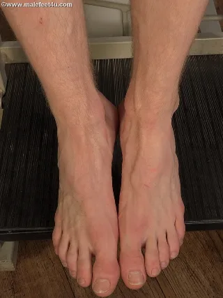 Peto Mohac’s bare soles pressed tight on dark mat, toes splayed, hairy calves framing foot-fetish focus