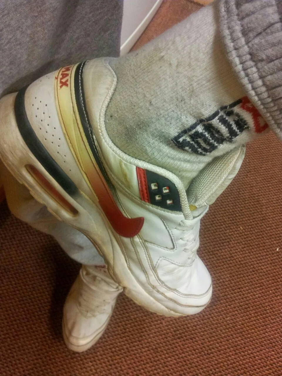 Dirty Nike Air Max sneakers with grimy socks and casual grey sweatpants