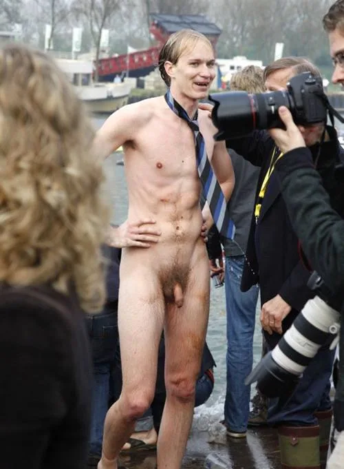 Skinny lad in tie posing nude by water as photographers snap shots