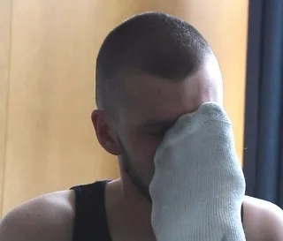 Guy in tank top playfully shoves socked foot in face, cheeky foot fetish tease